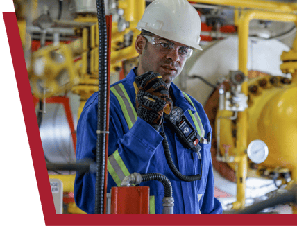 Un employé du secteur pétrolier et gazier utilise le micro RSM de Blackline Safety pour communiquer avec son équipe.